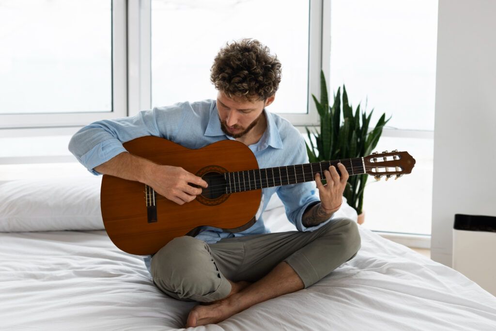 Hombre toca la guitarra acústica