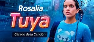 En la imagen está Rosalía sosteniendo un paraguas y está escrito: Tuya - Rosalía - Cifrado de la Canción