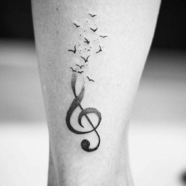 Tatuagem de nota musical e pássaros
